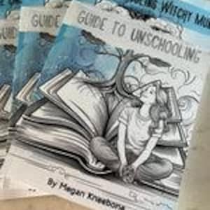 May include: Three copies of a blue and white guide to unschooling with a cartoon illustration of a person sitting on a large open book. The book has a tree growing out of it and the person is looking up at the sky. The title of the book is "The Unschooling Witchy Mama Guide to Unschooling" by Megan Kneebone.