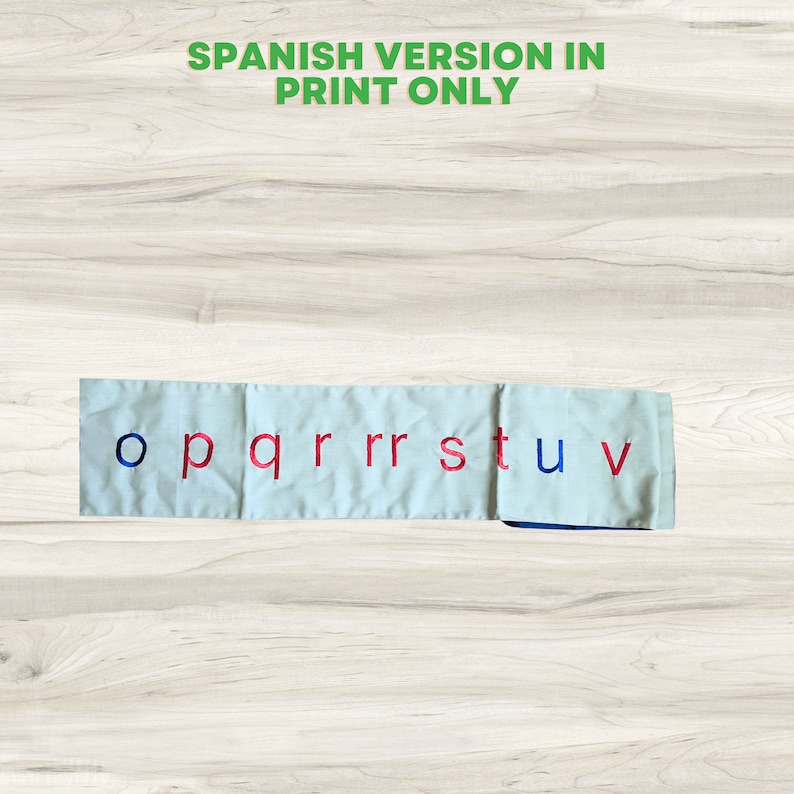 May include: A white fabric strip with the letters o, p, q, r, r, s, t, u, and v embroidered in red and blue.