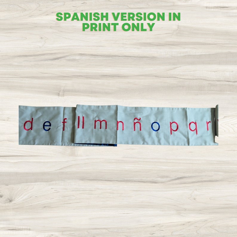 May include: A set of fabric squares with the letters d, e, f, ll, m, n, &ntilde;, o, p, q, and r printed in red on a light blue background. The squares are arranged in a row and are connected by a metal strip.