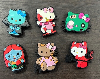 May include: Six colourful Hello Kitty themed Halloween character figurines. The characters are dressed as a zombie bride, a devil, a witch, a Frankenstein's monster, a vampire, and a ghost.