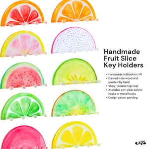 Functional and decorative lime slice key holder, equipped with four clear hooks for organizing keys and accessories