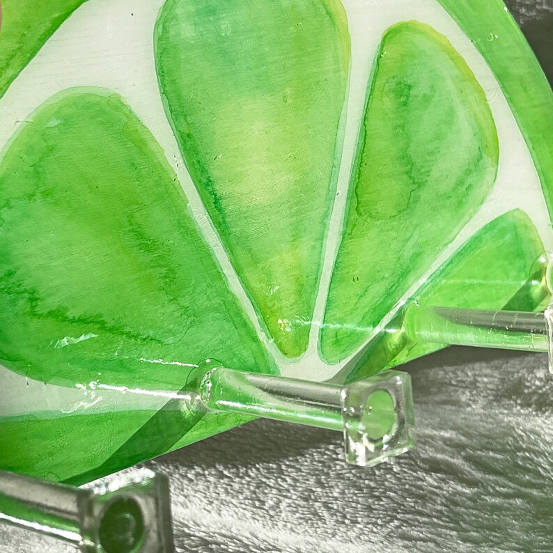 Close-up of the lime-themed key holder, highlighting the detailed hand-painted texture and bright citrus colors
