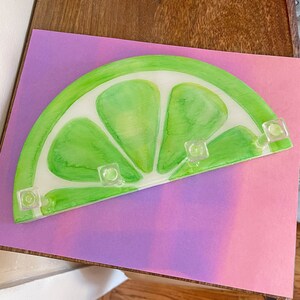 Handcrafted wooden key holder with a fresh lime theme, blending practicality with a touch of whimsy for home decor.