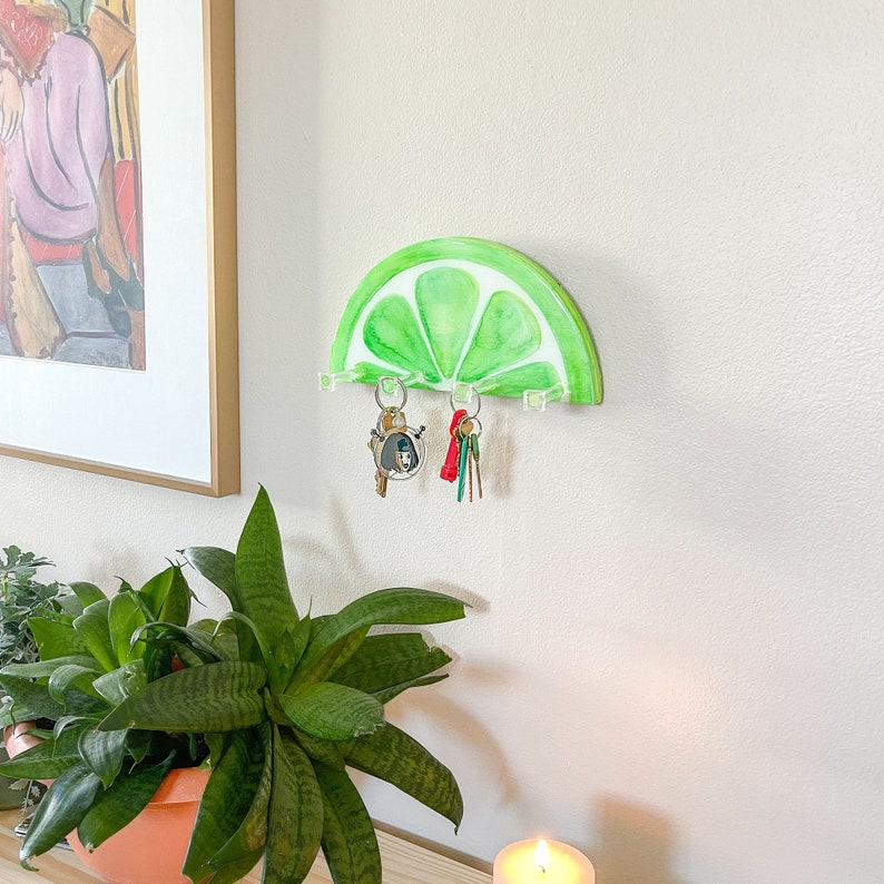 Artistic wall-mounted key holder crafted to resemble a fresh lime slice, ideal for adding a zesty touch to home decor