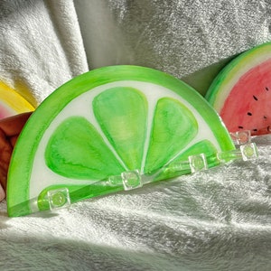 Unique hand-painted key holder inspired by a juicy lime slice, a creative addition to Etsy's home organization collection.