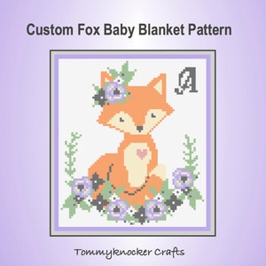 May include: A cross-stitch pattern featuring a fox with a flower crown and a heart on its chest. The fox is surrounded by flowers and greenery. The letter "A" is in the top right corner. The pattern is titled "Custom Fox Baby Blanket Pattern".