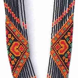 May include: A long black beaded necklace with colourful geometric patterns and fringe. The necklace features a central diamond-shaped design with a heart motif.