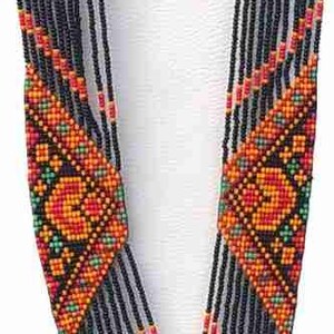 May include: A black beaded necklace with colourful geometric patterns and fringe. The necklace has a matching pair of earrings with the same design.