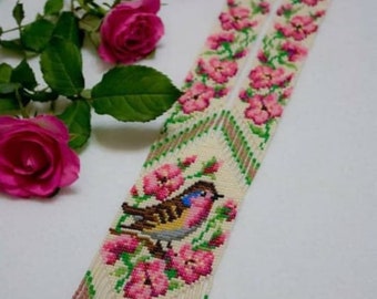 May include: A white beaded necklace with a pink and green floral design and a small bird in the center. The necklace has a fringe at the bottom. The text "Alena Fedorova with love" is at the bottom of the image.