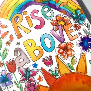 May include: Watercolor illustration with the words "Rise Above" in colorful letters. The image features a rainbow, flowers, a butterfly, and a sun. The artwork is bright and cheerful, with a hand-painted aesthetic.
