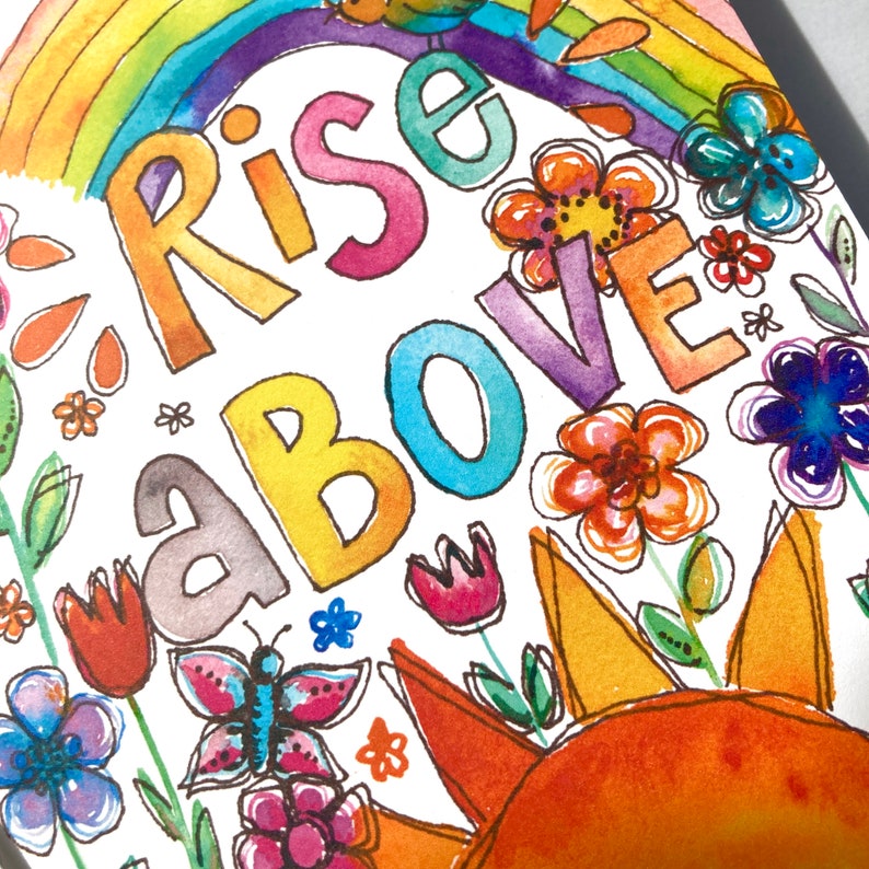 May include: Watercolor illustration with the words "Rise Above" in colorful letters. The image features a rainbow, flowers, a butterfly, and a sun. The artwork is bright and cheerful, with a hand-painted aesthetic.