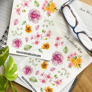 May include: Sheets of floral stickers featuring watercolor designs of pink and yellow flowers, green leaves, and pink petals. The stickers are on white paper, with the text "pink watercolor bliss" and "stickersbyjodi.etsy.com".