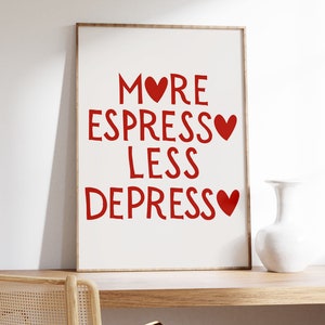 Könnte beinhalten: Ein gerahmter Druck mit dem Text "More Espresso Less Depresso" in roten Buchstaben mit einem roten Herzen nach jedem Wort.