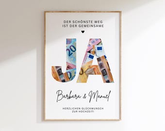 May include: A white poster with a black frame featuring the words "Der schönste Weg ist der gemeinsame" and "JA" in large black letters. The letters are filled with images of euro banknotes. Below the letters are the words "Barbara & Manuel" and "Herzlichen Glückwunsch zur Hochzeit!"
