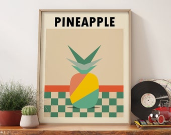 May include: A framed poster with a geometric design of a pineapple in shades of green, yellow, orange, and red. The poster is titled "PINEAPPLE" and is displayed on a wooden shelf with two wicker baskets, a record, and a toy truck.