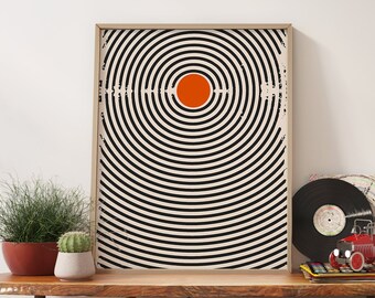 May include: A wooden table with a live edge top, two woven baskets, and a framed black and white print with an orange circle in the center. There are also vinyl records and a toy truck on the table.