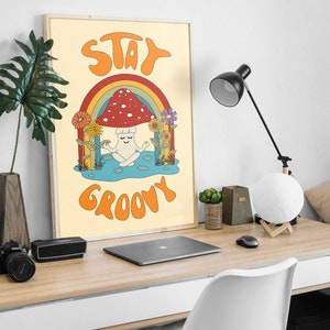 May include: A retro-style poster with a mushroom meditating under a rainbow. The poster has the text "Stay Groovy" in a colorful font.