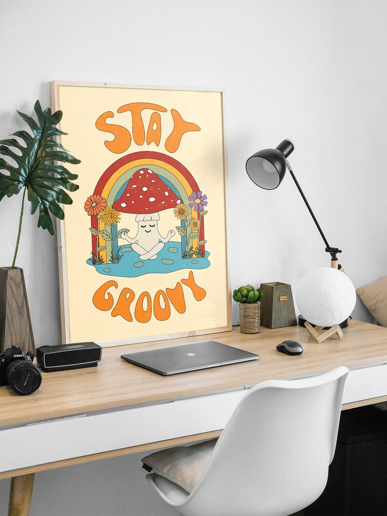 May include: A retro-style poster with a mushroom meditating under a rainbow. The poster has the text "Stay Groovy" in a colorful font.