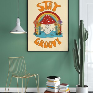 May include: A retro-style poster with a mushroom character meditating under a rainbow. The poster has the text "Stay Groovy" in a colorful font.