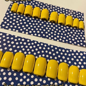May include: Two rows of yellow press-on nails, one row labelled "square" and the other labelled "square rounded".