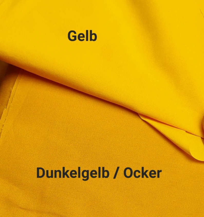 May include: Two layers of solid-colored fabric are displayed. The top layer is a bright, vibrant yellow with the text 'Gelb' printed on it. The bottom layer is a deeper, muted mustard yellow with the text 'Dunkelgelb / Ocker' printed below.