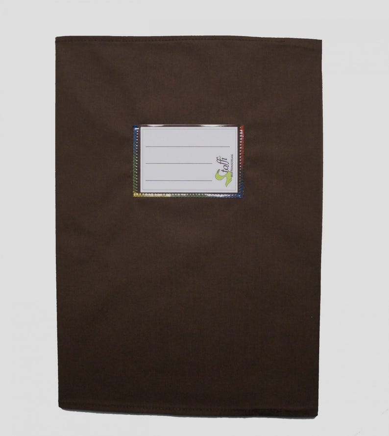 May include: A rectangular dark brown fabric pouch featuring a central white label window with three horizontal lines for writing. The label is bordered by a thin, multicolored rainbow-patterned trim and includes the green text logo toffi.