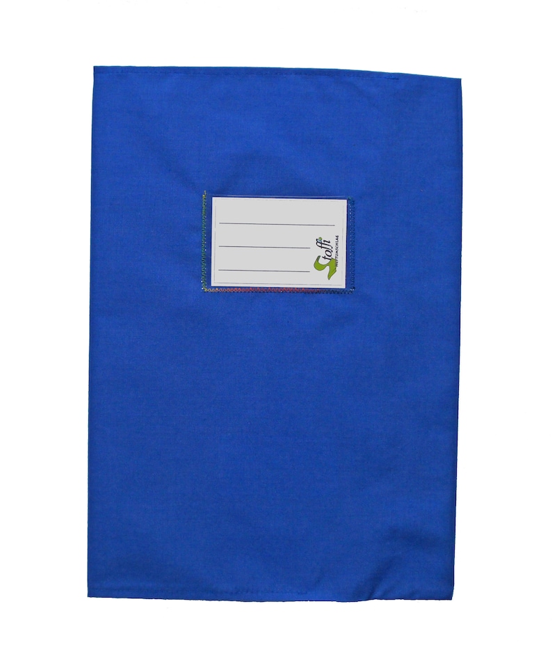 May include: A rectangular blue fabric book cover featuring a centered white label with three horizontal lines for writing and the green text "stoffi" printed on the right side. The label is stitched onto the blue fabric with a visible border.