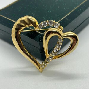 Vintage double  brooch/ pin in the form of a heart in gold tone with crystals.
