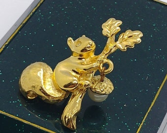 Vintage brooch in the form of a squirrel with a nut on gold tone