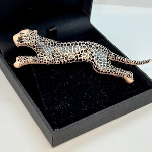 Vintage brooch in the form of a tiger, leopard, cheetah, panther made of  plastic with black  spots.