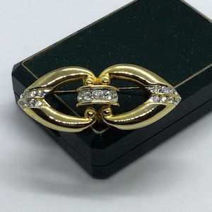 Vintage laconic brooch for men and women.Gold tone with blach and clear crystals.
