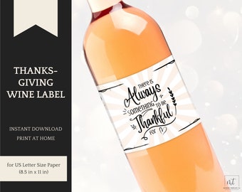 May include: Printable wine label with a pink and white striped background. The label features black text that reads "There is always something to be thankful for." with a heart symbol. The label is designed for a standard US letter size paper, 8.5 inches by 11 inches.