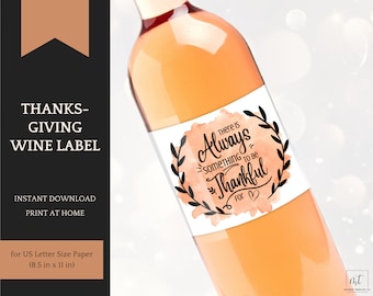 May include: Printable wine label with a watercolor background in shades of orange and white. The label features black text that reads "There is Always Something to Be Thankful For" with a heart symbol. The text is surrounded by a black wreath.