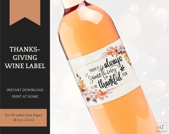 May include: A wine bottle with a label that reads "There is always something to be thankful for." The label has floral and leaf accents in shades of orange, brown, and pink. The text "Thanksgiving Wine Label" is also visible.