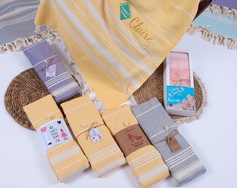May include: A set of six yellow and gray striped towels with personalized tags. The towels are wrapped with twine and have tags that say "Claire's Bridal Shower", "Claire's Bridesmaids", and "Happy Times Claire".