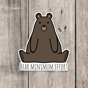 May include: A brown bear cartoon sticker with the text "Bear Minimum Effort" on a wood background.