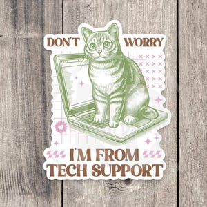 May include: A sticker with a green cat sitting on a laptop. The sticker says "Don't Worry I'm From Tech Support" in a retro font.
