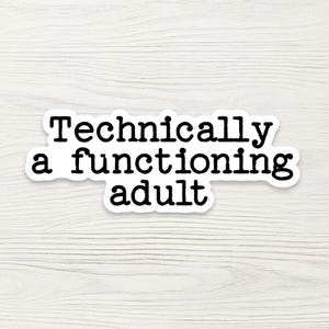 May include: A white sticker with the text "Technically a functioning adult" in black, sans-serif font. The sticker is on a light wood-grain background.