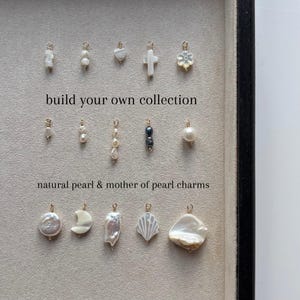 May include: A collection of natural pearl and mother of pearl charms arranged in three rows. The charms feature various shapes including crosses, flowers, moons, and irregular forms, each with a small gold loop. Text reads: build your own collection, natural pearl & mother of pearl charms.