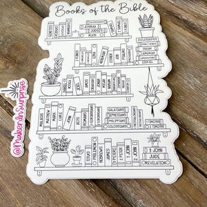 May include: A white sticker featuring a bookshelf design with the words "Books of the Bible" at the top. The sticker includes illustrations of potted plants and the names of the books of the Bible. The sticker has a decorative border.