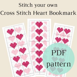 May include: Three cross stitch patterns for a heart bookmark. The patterns are printed on white paper with a grid and feature pink and red hearts. The text "PDF pattern" is on a teal circle.