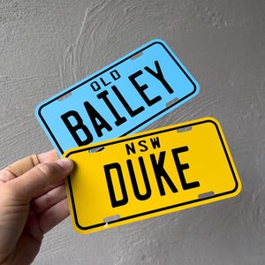 May include: Two personalised number plates, one blue with "OLD BAILEY" and one yellow with "NSW DUKE".