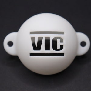 May include: White plastic ball with a black "VIC" logo and two loops on the sides.
