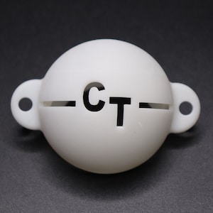May include: White plastic golf ball retriever with a black "CT" logo and a slot for retrieving golf balls.