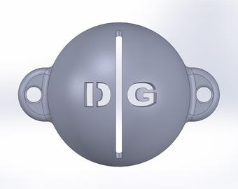 May include: A gray, spherical object with the letters "IDG" cut out on the front. A vertical line bisects the sphere. Two loop-shaped attachments with holes are on either side.