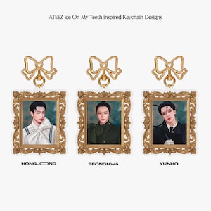 May include: Three gold-framed keychain charms featuring portraits of three different people. Each charm has a gold bow at the top and the names "Hongjoong", "Seonghwa", and "Yunho" are printed below the charms.