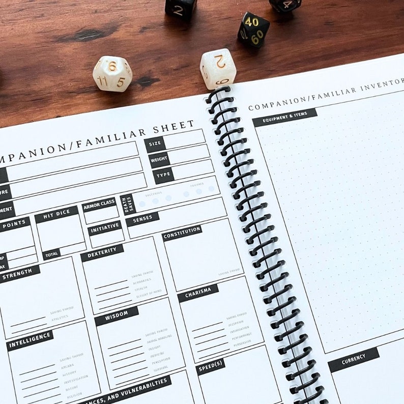 May include: A black and white companion/familiar character sheet with a spiral binding. The sheet has sections for stats, abilities, and equipment. The sheet is open to a page titled "Companion/Familiar Inventor" with a section for "Equipment & Items".