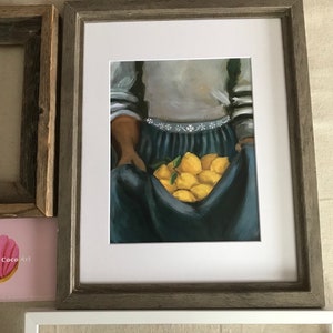 May include: A painting of a person holding a basket of lemons. The person is wearing a blue skirt and a white shirt with a floral pattern. The lemons are yellow and green.