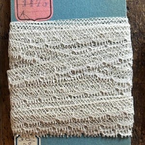 Just over 9 meters of the French intricate antique fine skinny 13mm wide off white lace on original labelled card. Excellent condition!