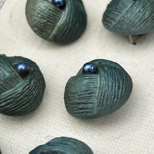 Set of 12 matching vintage dark green woven buttons on original card. Very good condition! Likely French made. Partial card. Costume buttons